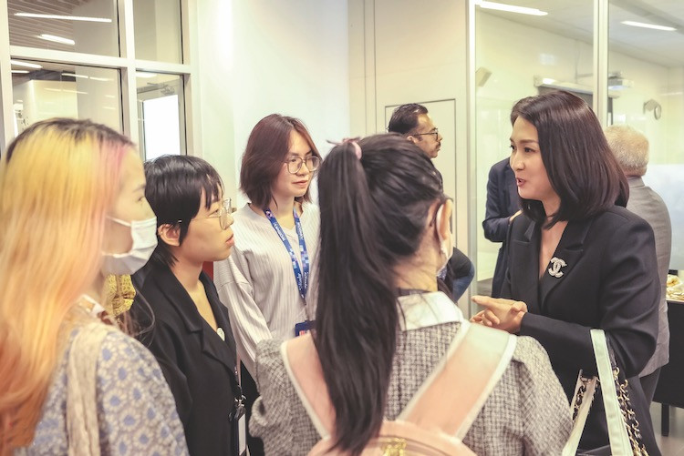 • Chị Nguyễn Lê Chi Mai (bên phải) chia sẻ hành trình của mình với các bạn sinh viên trong khuôn khổ triển lãm "Women.Building.Businesses"